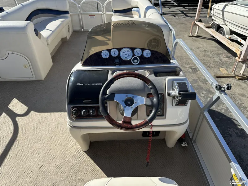 Slide: The Image of 2005 Sun Tracker PARTY BARGE 25 boat interior with steering wheel and seating. - 14