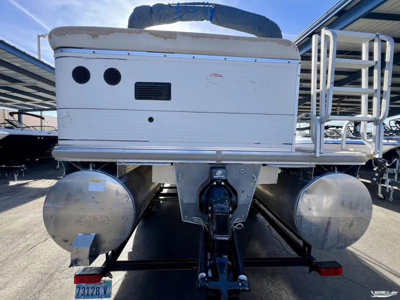 Slide: The Image of 2005 Sun Tracker PARTY BARGE 25 pontoon boat rear view with trailer in storage. - 21