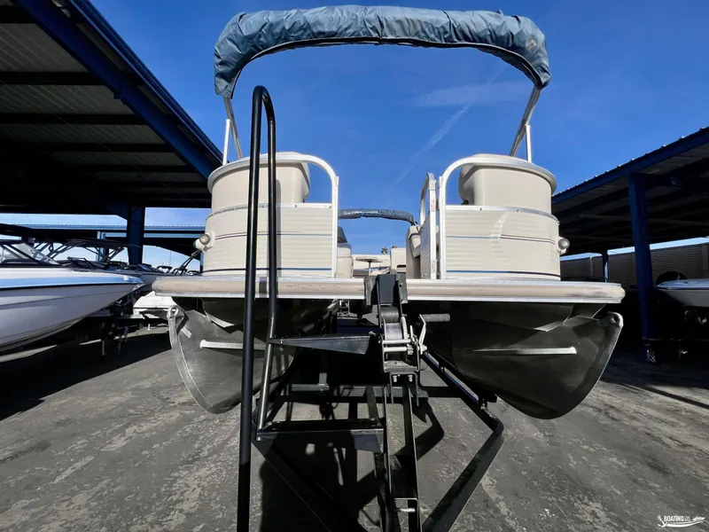 Slide: The Image of 2005 Sun Tracker PARTY BARGE 25 pontoon boat on trailer under blue sky. - 4