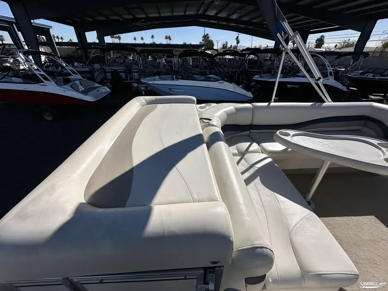 Slide: The Image of 2005 Sun Tracker PARTY BARGE 25 interior with seating and table, under a covered area. - 9