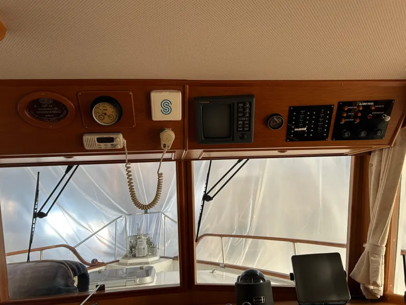 Slide: The Image of Interior helm of 1999 Grand Banks Classic yacht with navigation instruments and controls. - 10