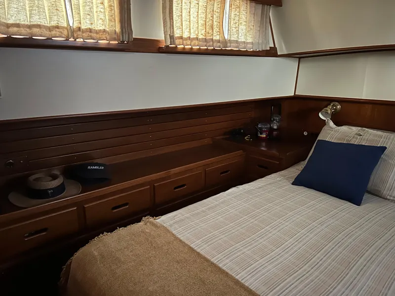 Slide: The Image of Cozy cabin interior of 1999 Grand Banks Classic yacht with wood paneling and comfortable bedding. - 13