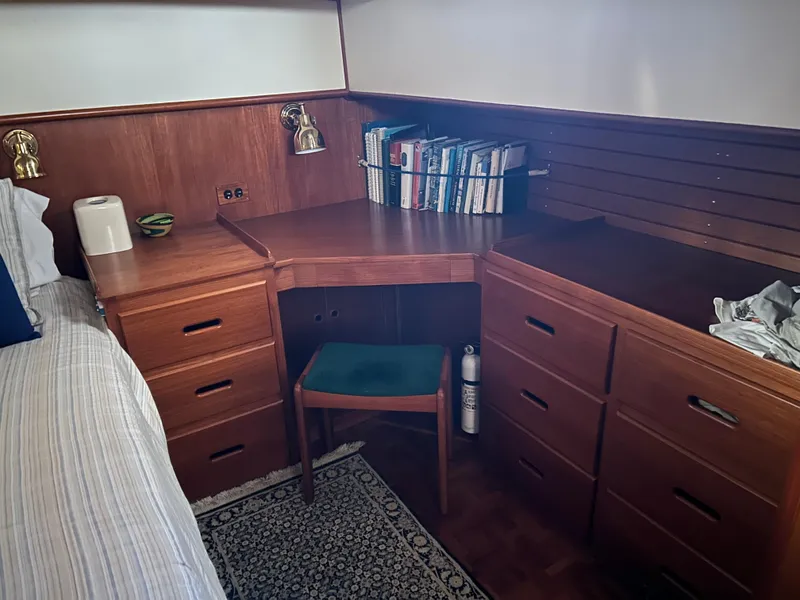 Slide: The Image of Cozy cabin interior of 1999 Grand Banks Classic with wooden desk and storage. - 14