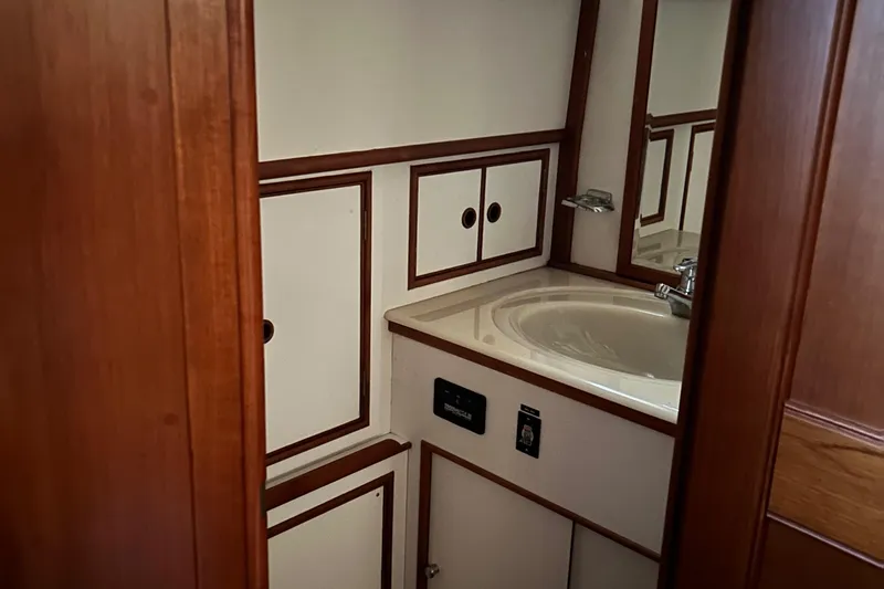 Slide: The Image of Bathroom interior of 1999 Grand Banks Classic yacht with wooden cabinetry and sink. - 15