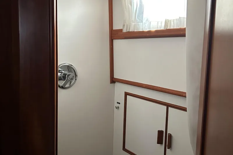 Slide: The Image of Interior of 1999 Grand Banks Classic yacht, featuring wooden trim and cabinetry. - 16