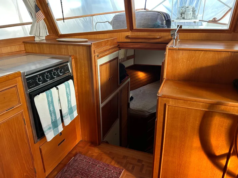 Slide: The Image of 1999 Grand Banks Classic yacht interior with wood cabinetry and cozy cabin space. - 17