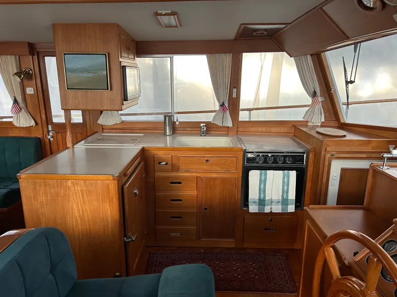 Slide: The Image of Interior of 1999 Grand Banks Classic yacht with wooden cabinetry and kitchen appliances. - 3