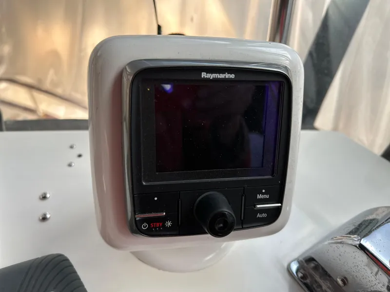 Slide: The Image of Raymarine navigation device on 1999 Grand Banks Classic boat dashboard. - 31