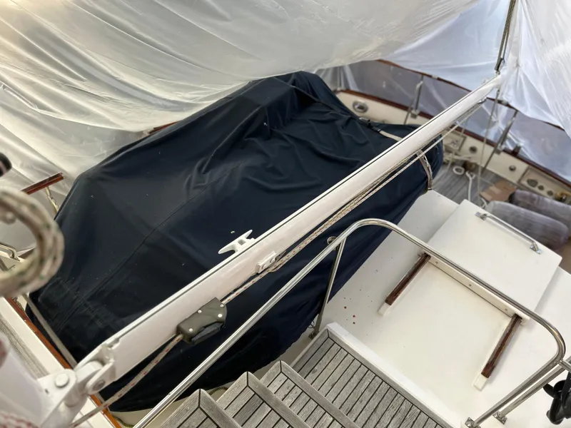 Slide: The Image of 1999 Grand Banks Classic yacht deck with covered equipment and railing. - 33