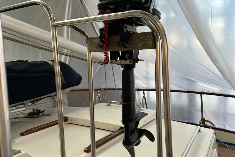 Slide: The Image of 1999 Grand Banks Classic boat deck with motor and railing. - 34