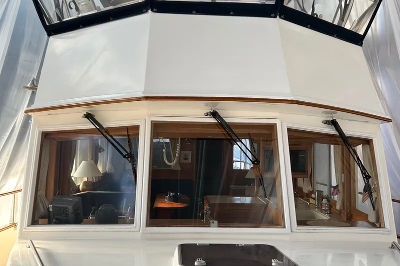 Slide: The Image of 1999 Grand Banks Classic boat cabin with large windows and interior view. - 35
