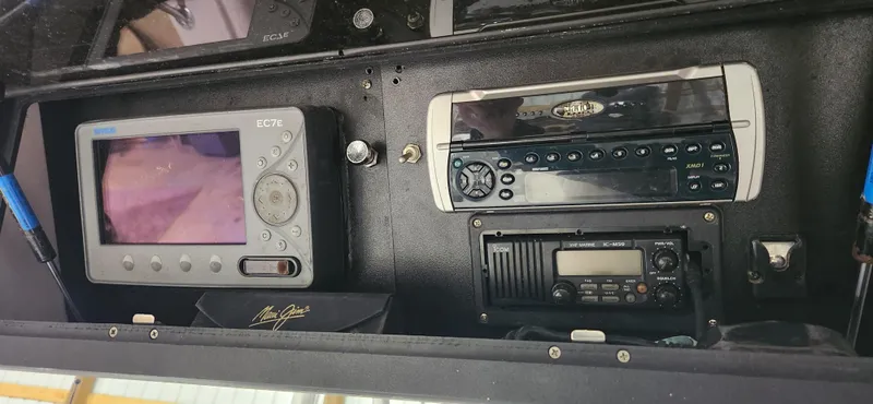 Slide: The Image of Electronics panel on a 1999 Boston Whaler 23 Outrage boat, featuring navigation and communication devices. - 11