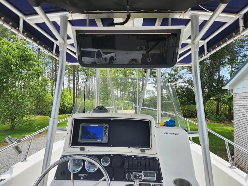 Slide: The Image of 1999 Boston Whaler 23 Outrage boat dashboard with navigation equipment and canopy. - 14