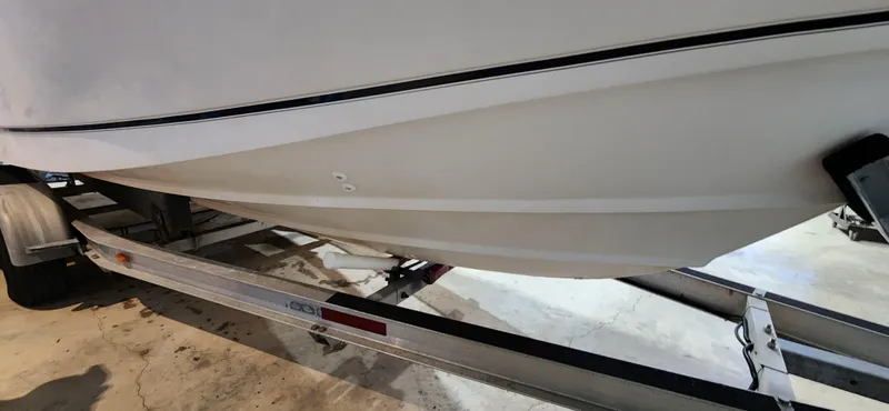 Slide: The Image of 1999 Boston Whaler 23 Outrage boat on trailer, side view. - 19