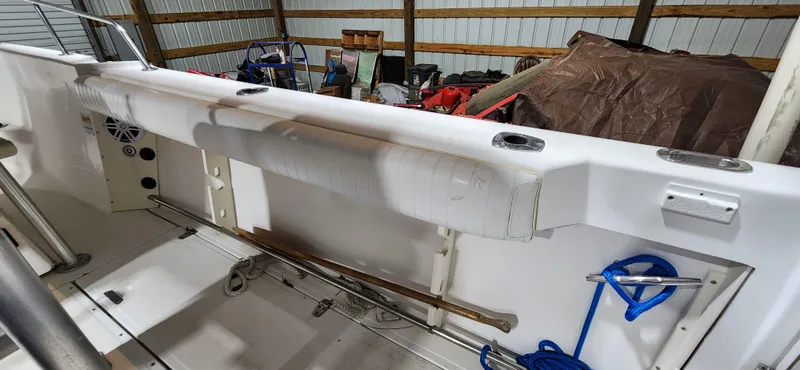 Slide: The Image of 1999 Boston Whaler 23 Outrage interior, showing seating and storage in a garage setting. - 22
