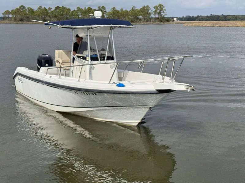 Slide: The Image of 1999 Boston Whaler 23 Outrage boat cruising on calm water. - 3