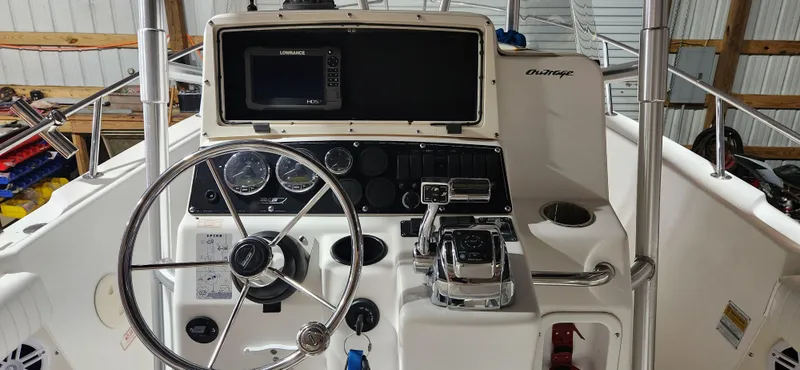 Slide: The Image of 1999 Boston Whaler 23 Outrage boat console with steering wheel and navigation equipment. - 9
