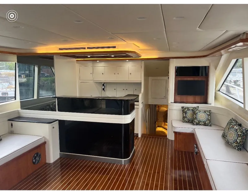 Slide: The Image of Luxurious interior of a 1990 Striker Sportfish yacht with elegant wood flooring and modern seating. - 11
