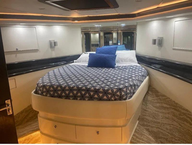 Slide: The Image of Luxurious cabin interior of a 1990 Striker Sportfish yacht with a cozy bed and modern decor. - 12