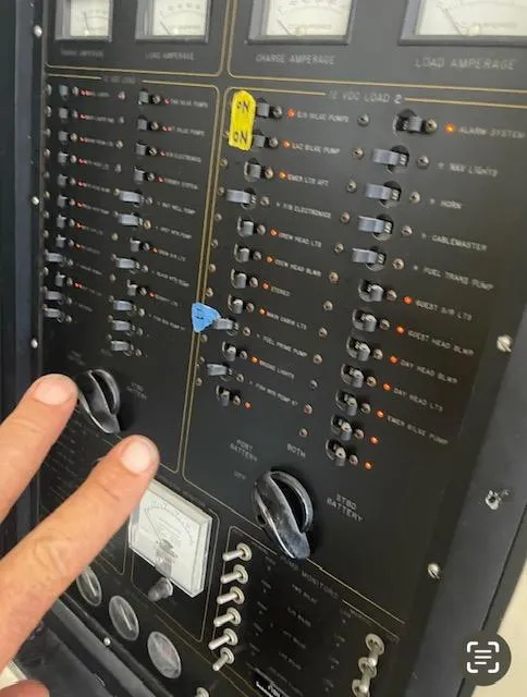 Slide: The Image of Control panel of a 1990 Striker Sportfish boat with switches and gauges. - 19