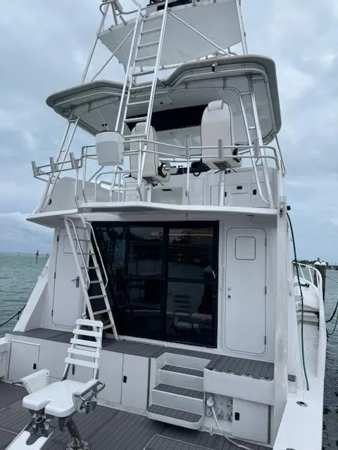 Slide: The Image of 1990 Striker Sportfish boat with tower, docked on a cloudy day. - 3