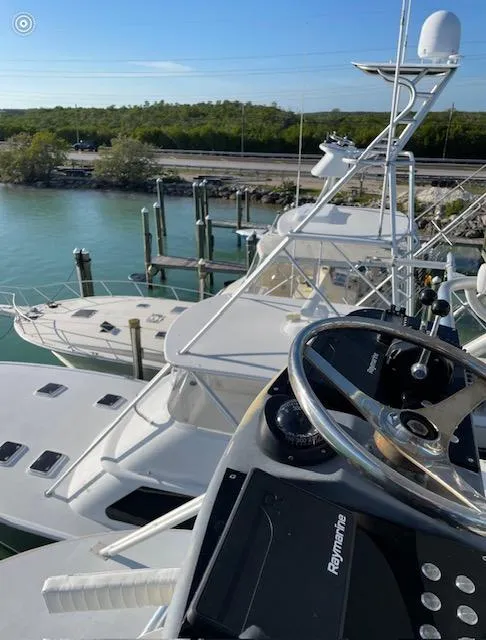 Slide: The Image of 1990 Striker Sportfish yacht docked, featuring sleek design and modern navigation equipment. - 5