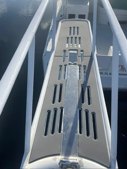 Slide: The Image of 1990 Striker Sportfish boat deck with metal railings and non-slip surface. - 7