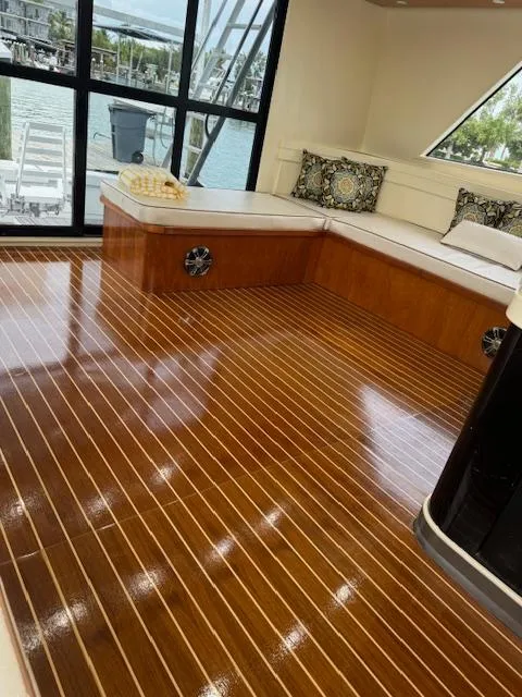 Slide: The Image of Luxurious 1990 Striker Sportfish yacht interior with polished wood flooring and elegant seating. - 8