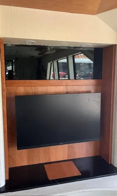 Slide: The Image of Built-in TV on a 1990 Striker Sportfish yacht with wood paneling. - 9