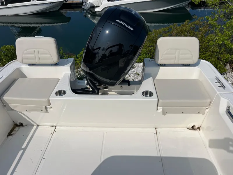 Slide: The Image of 2025 Boston Whaler 190 Montauk boat interior with seating and outboard motor. - 3