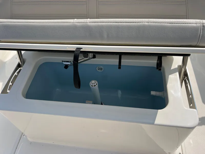Slide: The Image of 2025 Boston Whaler 190 Montauk boat livewell with open lid and seating. - 4