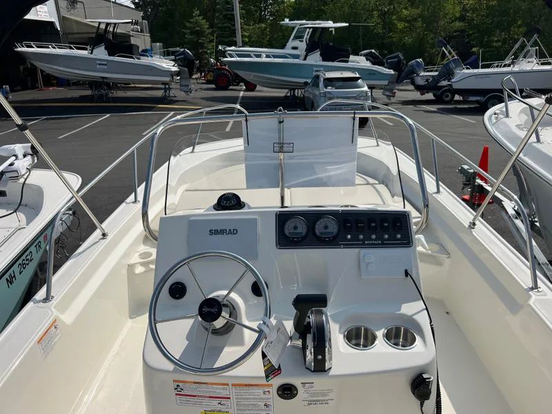 Slide: The Image of 2025 Boston Whaler 190 Montauk boat interior with steering console and gauges. - 5