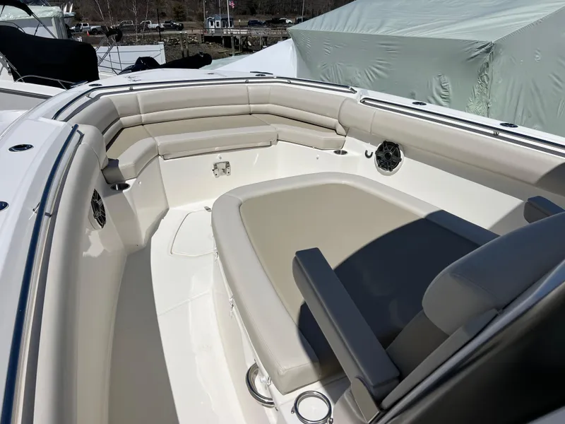 Slide: The Image of 2025 Boston Whaler 330 Outrage boat interior with cushioned seating and sleek design. - 3
