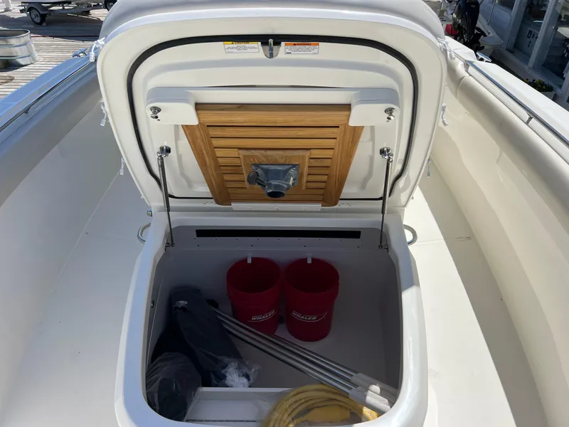 Slide: The Image of 2025 Boston Whaler 330 Outrage storage compartment with equipment and accessories. - 5