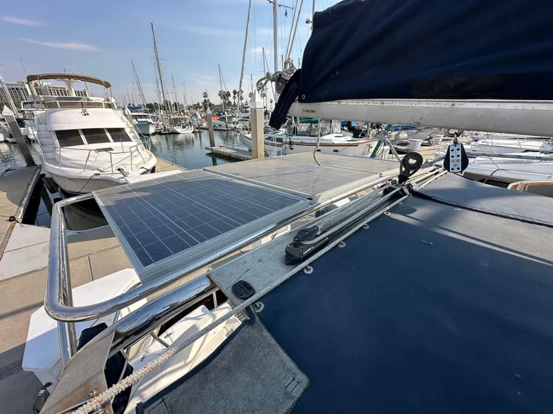 Slide: The Image of 2001 Hunter 380 sailboat with solar panels docked at marina. - 18