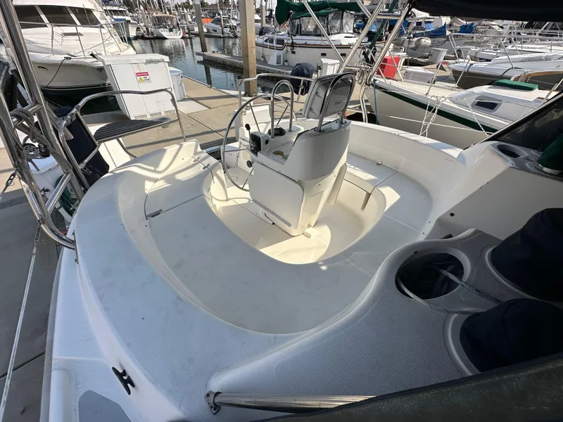 Slide: The Image of 2001 Hunter 380 sailboat cockpit with steering wheel, docked at marina. - 19