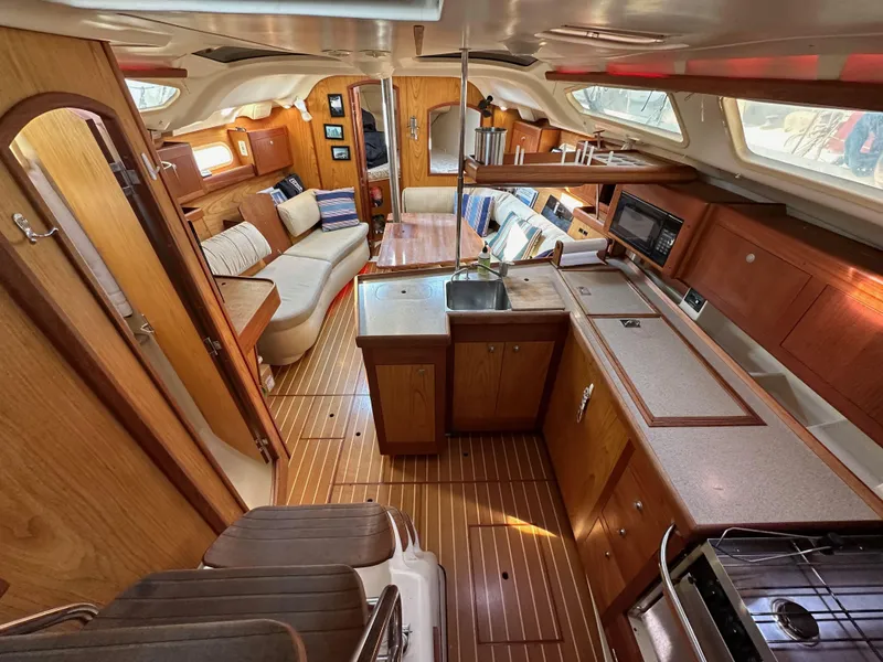 Slide: The Image of Interior of 2001 Hunter 380 sailboat with wood finish and modern amenities. - 21