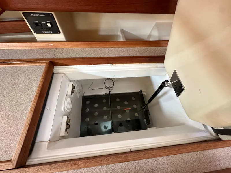 Slide: The Image of Open storage compartment in a 2001 Hunter 380 boat interior. - 28