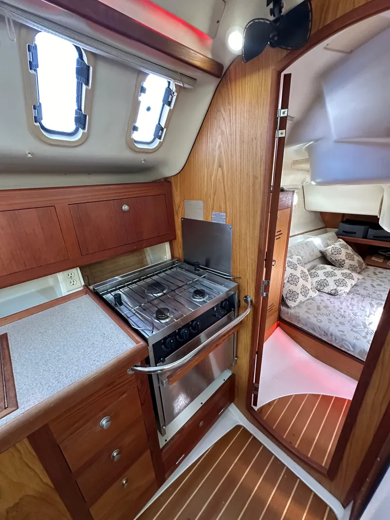 Slide: The Image of Interior of 2001 Hunter 380 sailboat with kitchen and cozy sleeping area. - 29