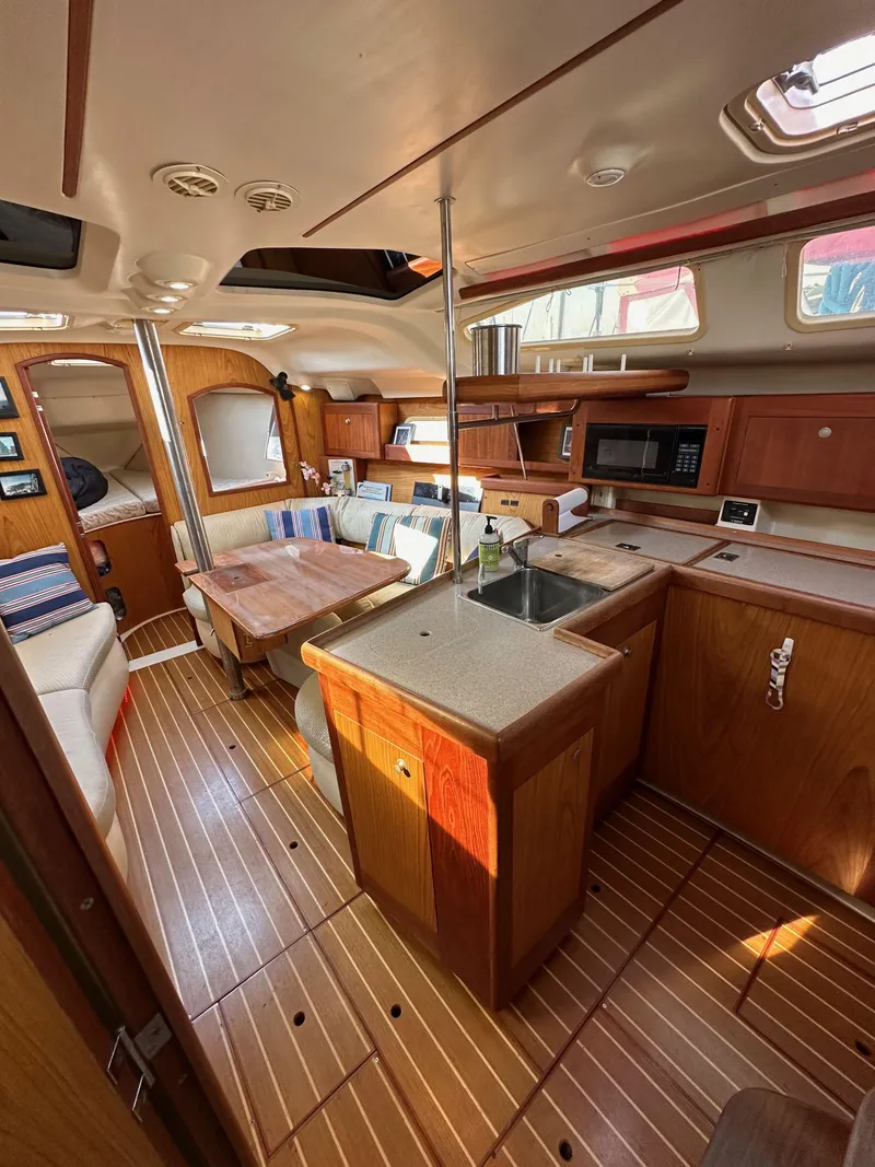 Slide: The Image of Interior of 2001 Hunter 380 sailboat with wood finish and modern amenities. - 34