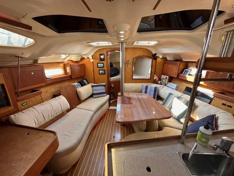 Slide: The Image of Interior of a 2001 Hunter 380 sailboat with cozy seating and wooden finishes. - 35