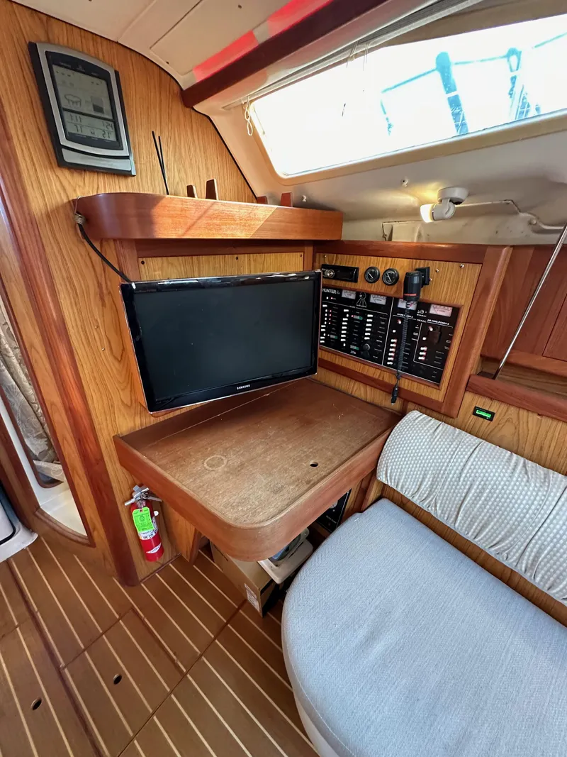 Slide: The Image of Interior of 2001 Hunter 380 sailboat with navigation equipment and seating area. - 36