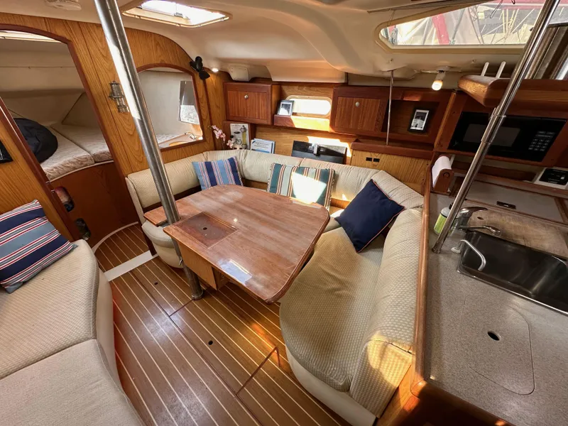 Slide: The Image of Interior of 2001 Hunter 380 sailboat with cozy seating and wooden finishes. - 37