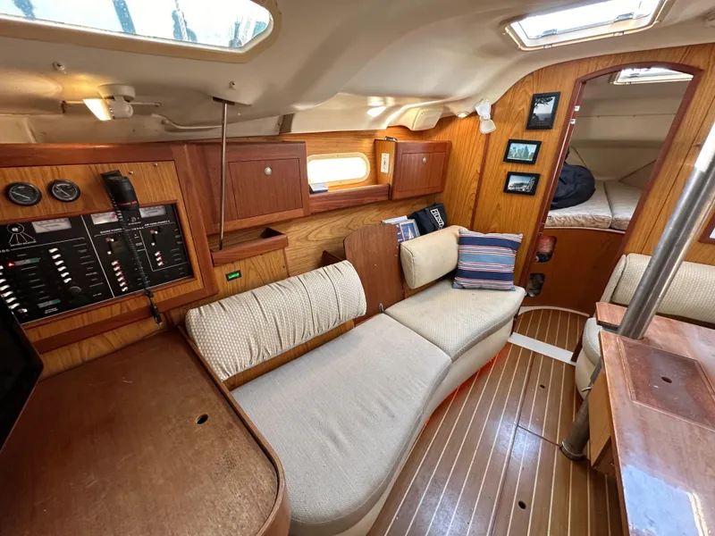 Slide: The Image of Interior of 2001 Hunter 380 sailboat with wood paneling and cozy seating area. - 38