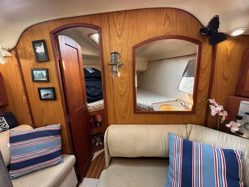 Slide: The Image of Interior of 2001 Hunter 380 sailboat with cozy seating and wooden paneling. - 39