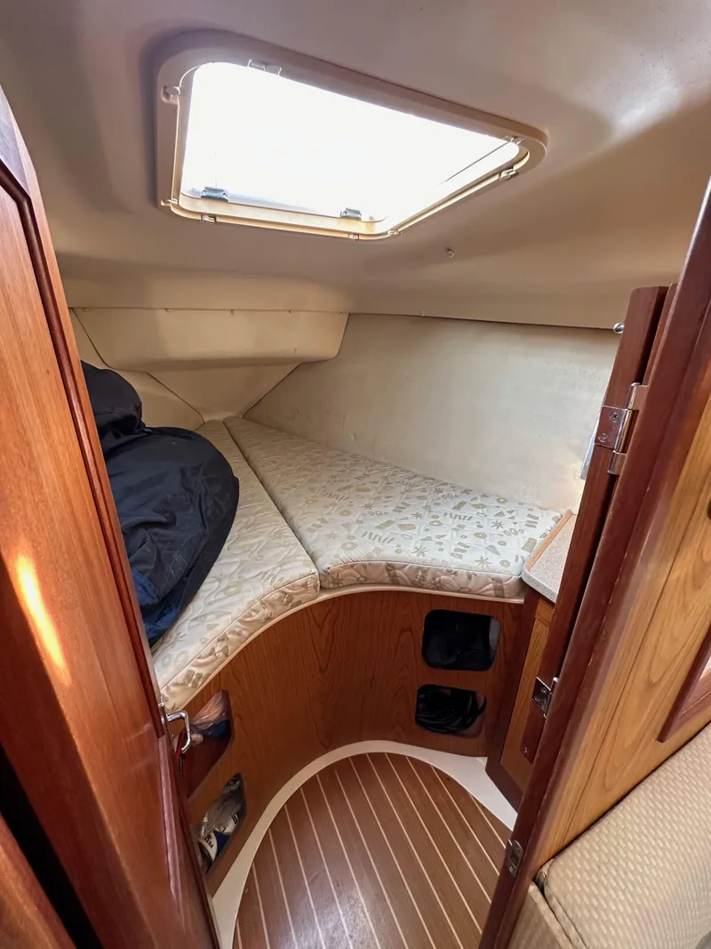 Slide: The Image of Interior cabin of 2001 Hunter 380 sailboat with wooden finish and bedding. - 40