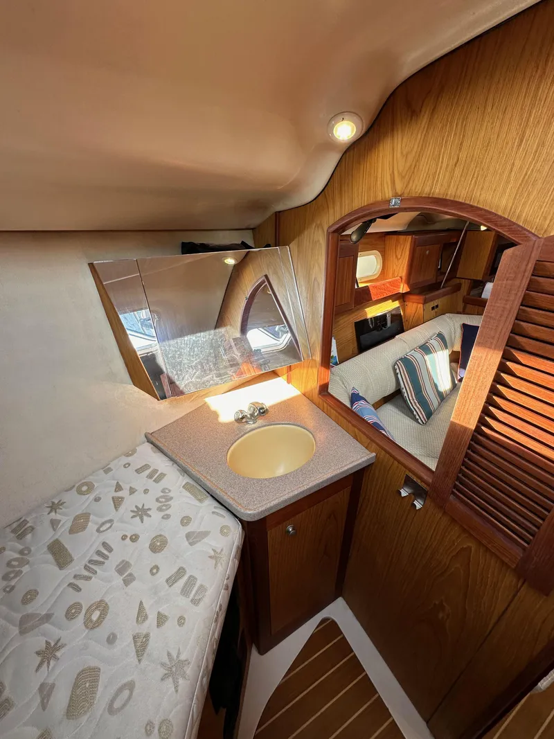 Slide: The Image of Interior of 2001 Hunter 380 yacht with wooden cabinetry and compact sink area. - 41