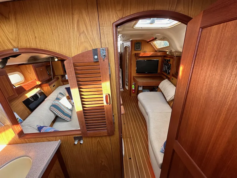 Slide: The Image of Interior of 2001 Hunter 380 sailboat with wooden finish and cozy seating area. - 42