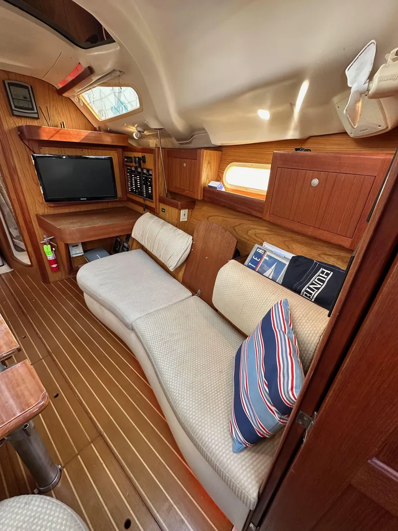 Slide: The Image of Interior of 2001 Hunter 380 sailboat with cozy seating and wooden finishes. - 43