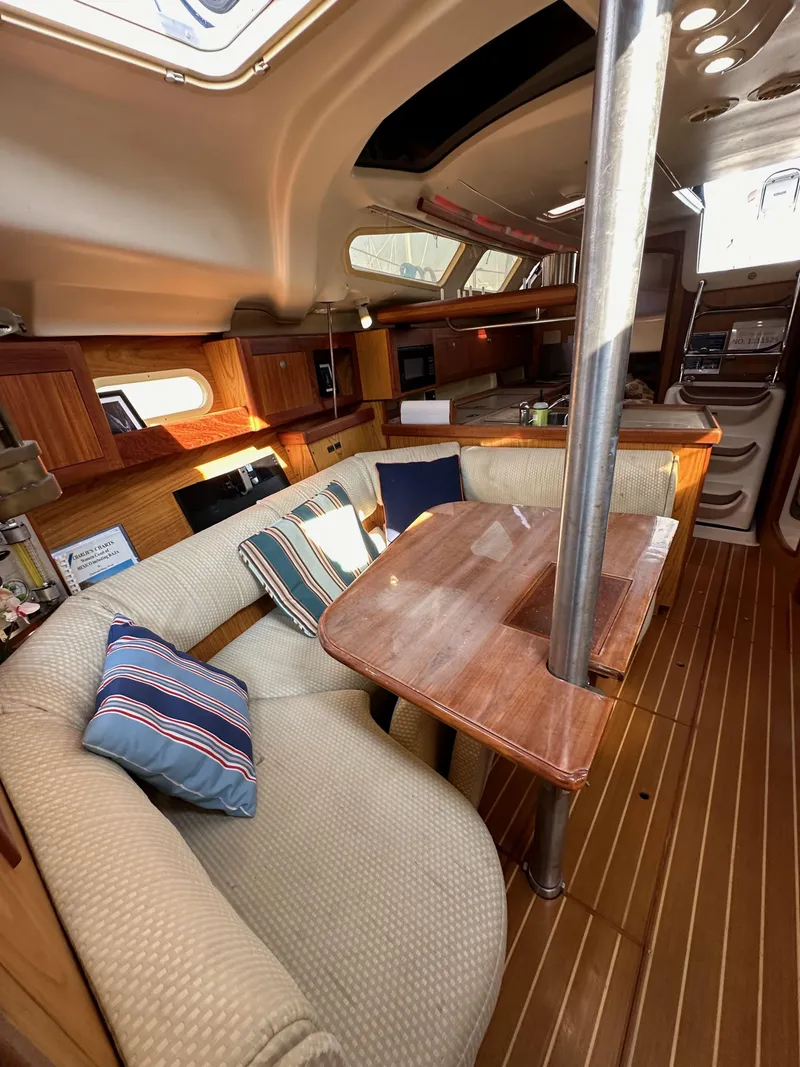 Slide: The Image of Interior of 2001 Hunter 380 sailboat with cozy seating and wooden table. - 44